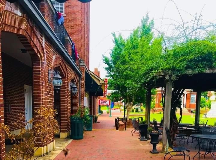 Brick sidewalks, shops, and outdoor seating in historic downtown Dublin, GA, 10 minutes from Honeysuckle Farm RV Park